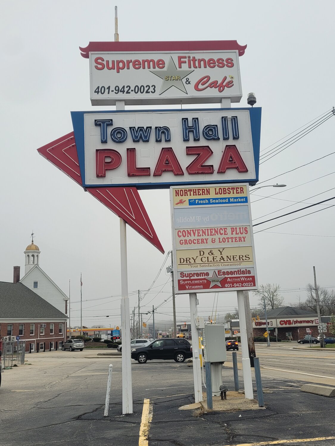 TOWN HALL PLAZA IN RUINS: One of the Grieco brothers is also tied to the refurbishment of the strip mall next to Johnston Town Hall (seen here in a photo taken several months ago), which formerly housed a gym, café and the Johnston Democratic Headquarters. The property has been fenced off for months; businesses closed. The fence-line perimeter was recently extended closer to Atwood Avenue. Robert Grieco confirmed the property was not directly owned by the auto group, but one of his brothers was involved with the project. He promised to have plans sent to the Johnston Sun Rise this week, but they did not arrive by press-time.